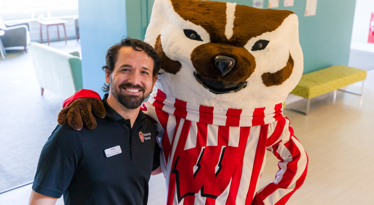 Bucky Badger poses with a staff member