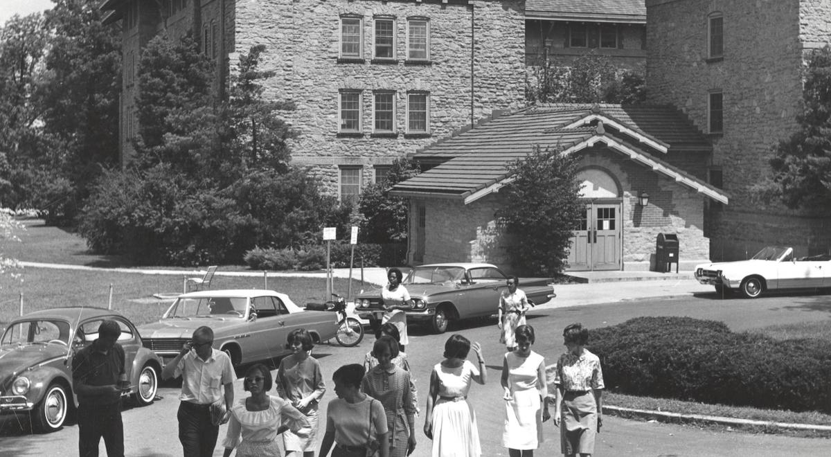 A black and white photo from the 1960s of students walking out of Tripp Residence Hall
