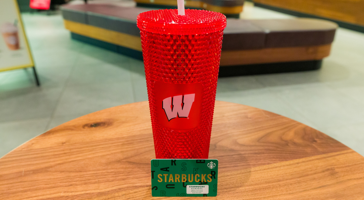 A red Wisconsin straw cup and gift card available at Starbucks in Smith