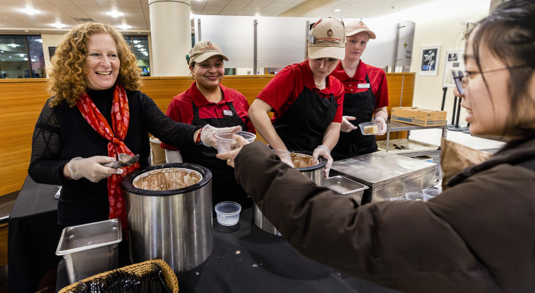 Chancellor Mnookin and three Dining students serve ice cream at Gordon