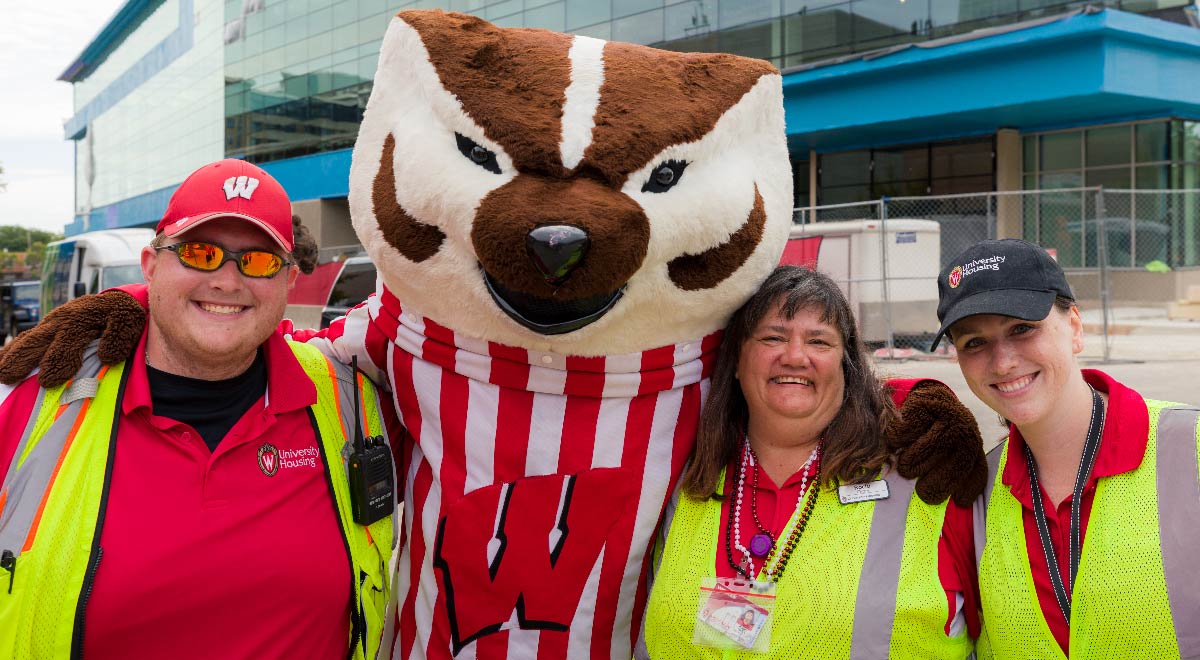 Housing staff pose with Bucky Badger