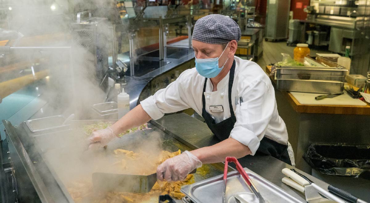 A chef cooking food at Four Lakes Market