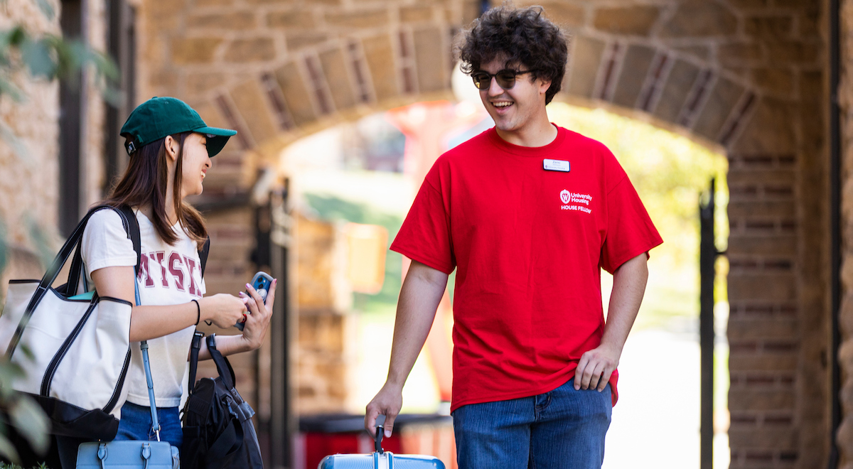 House Fellow Zeno Wilson helps Michika Hoshi carry her stuff to her room during fall move-in at the University of Wisconsin-Madison.
