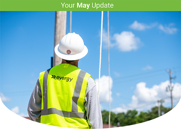 image of a lineman in a safety vest gazing at a sunny sky