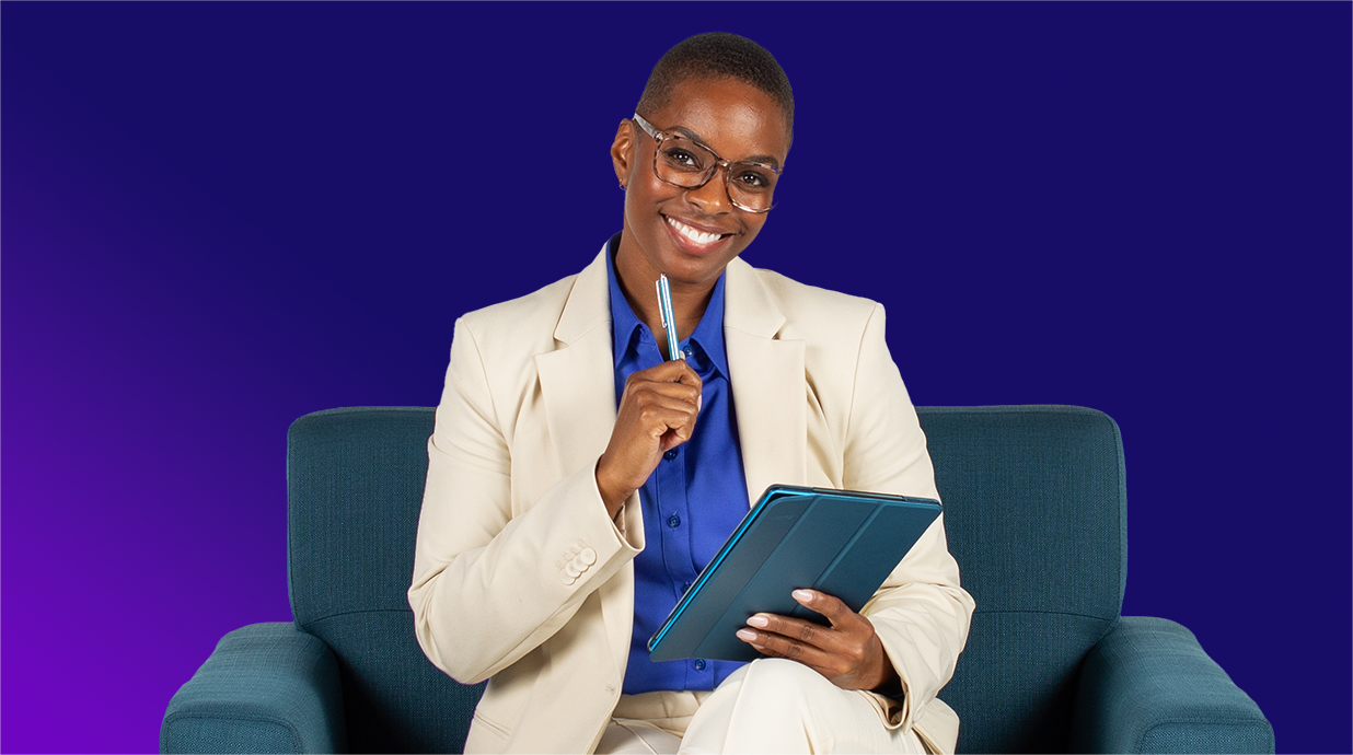 Zoe sitting on a chair and holding a tablet