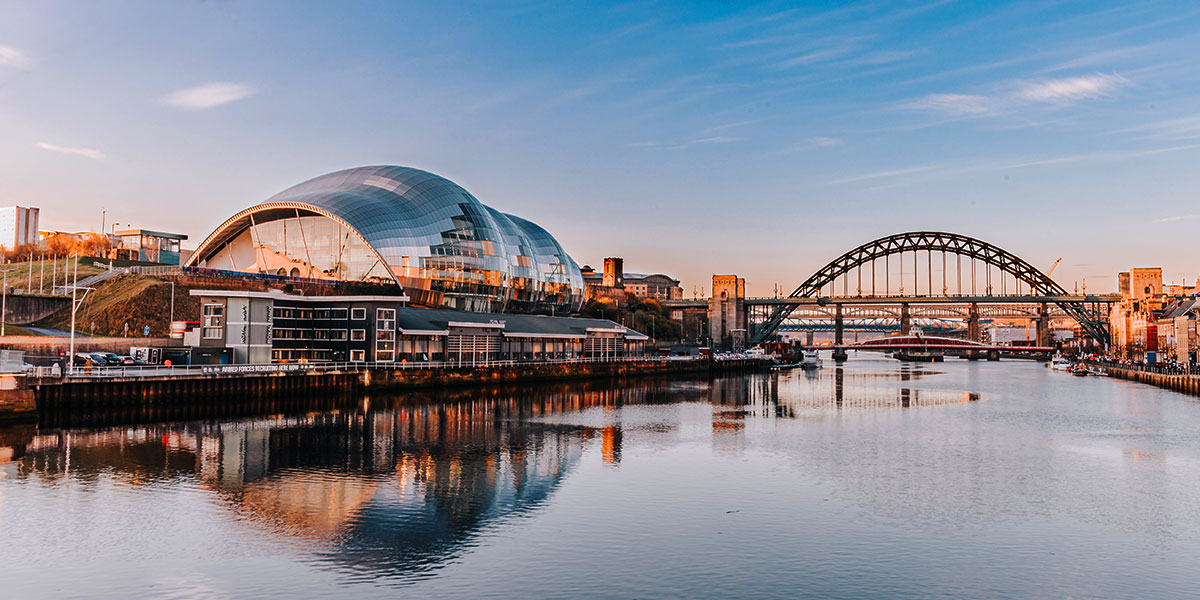 Image of bridge, river and domed building with mirrored roof in Newcastle upon Tyne, UK