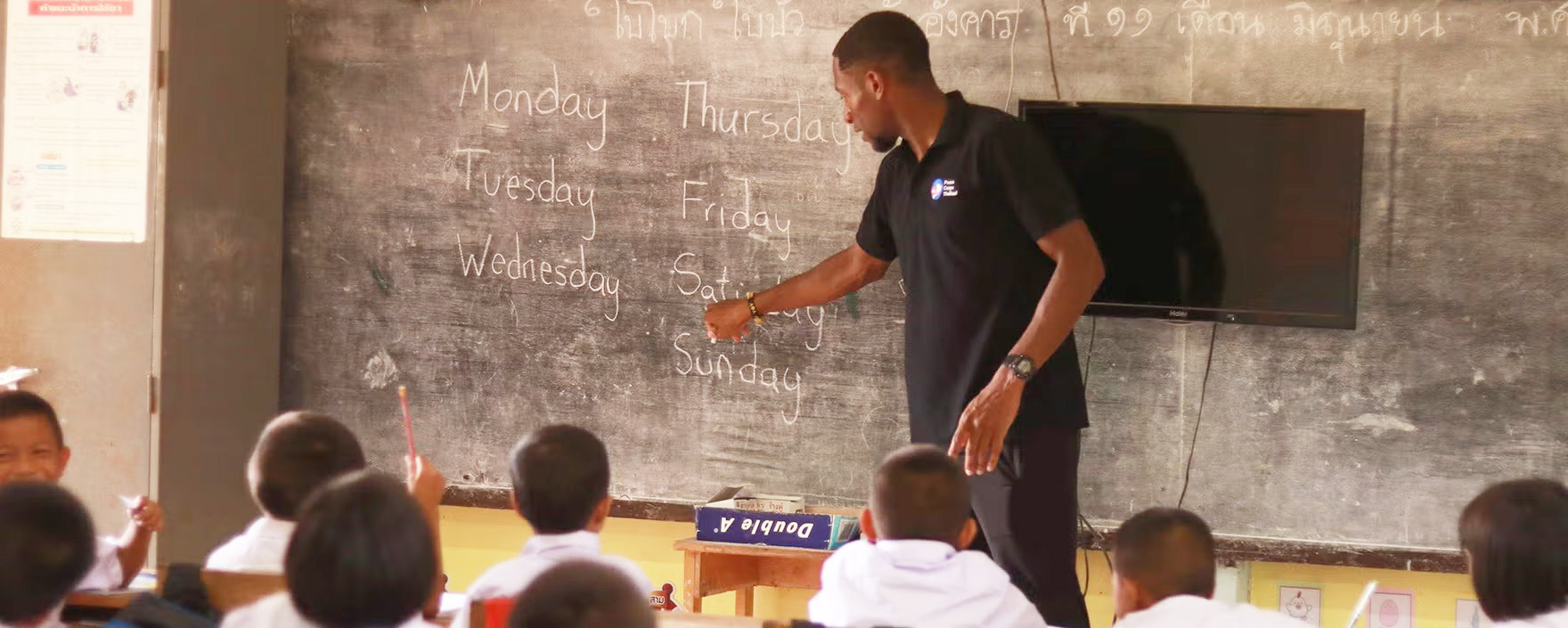 Peace Corps Volunteer teaching in classroom
