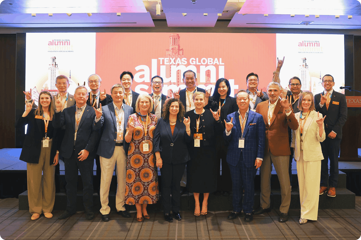 UT Austin International Leadership Council posing in front of summit stage