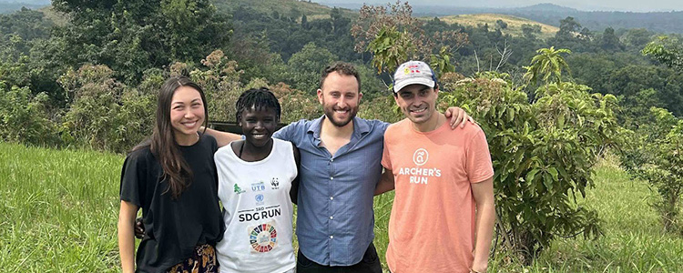 Researchers standing together in front of the jungle