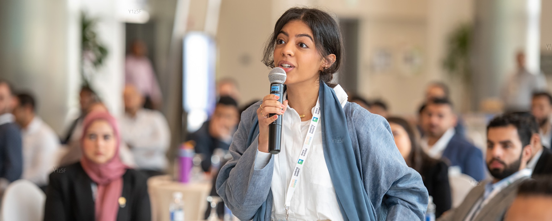 Student with a microphone at an event