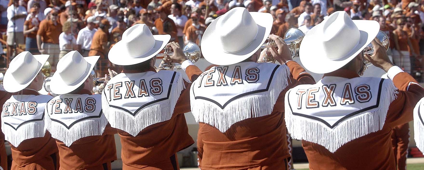 Longhorn band trumpet line playing at a football game