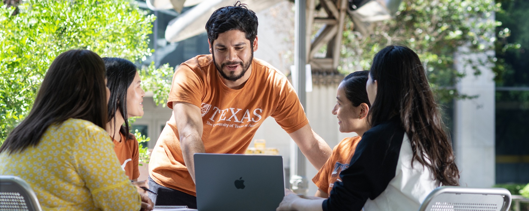 Group of ELC students studying outside with a laptop