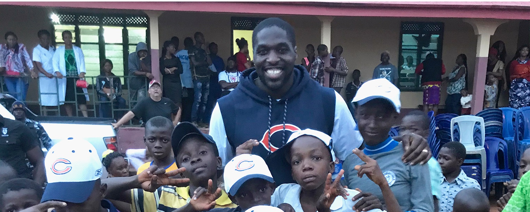 Sam Acho with group of children