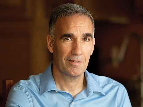 Dr. Kucharik smiles and wears a light blue button up.