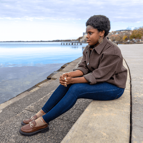 Maryhilda Obasiota Ibe sits by Lake Mendota at Memorial Union