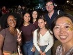 A group of students poses for the camera at a social event