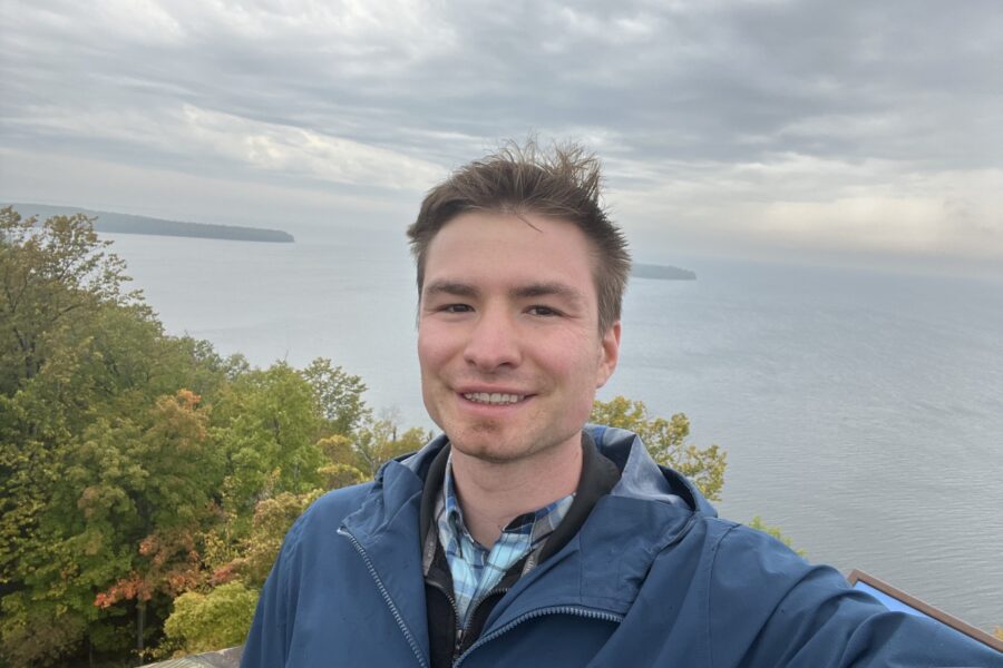 Jack Plasterer poses in front of a body of water