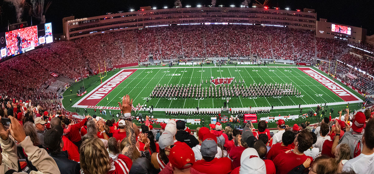 Badger fans cheer during halftime band show at Camp Randall.
