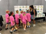 A group of children look at a table full of LEGO maps