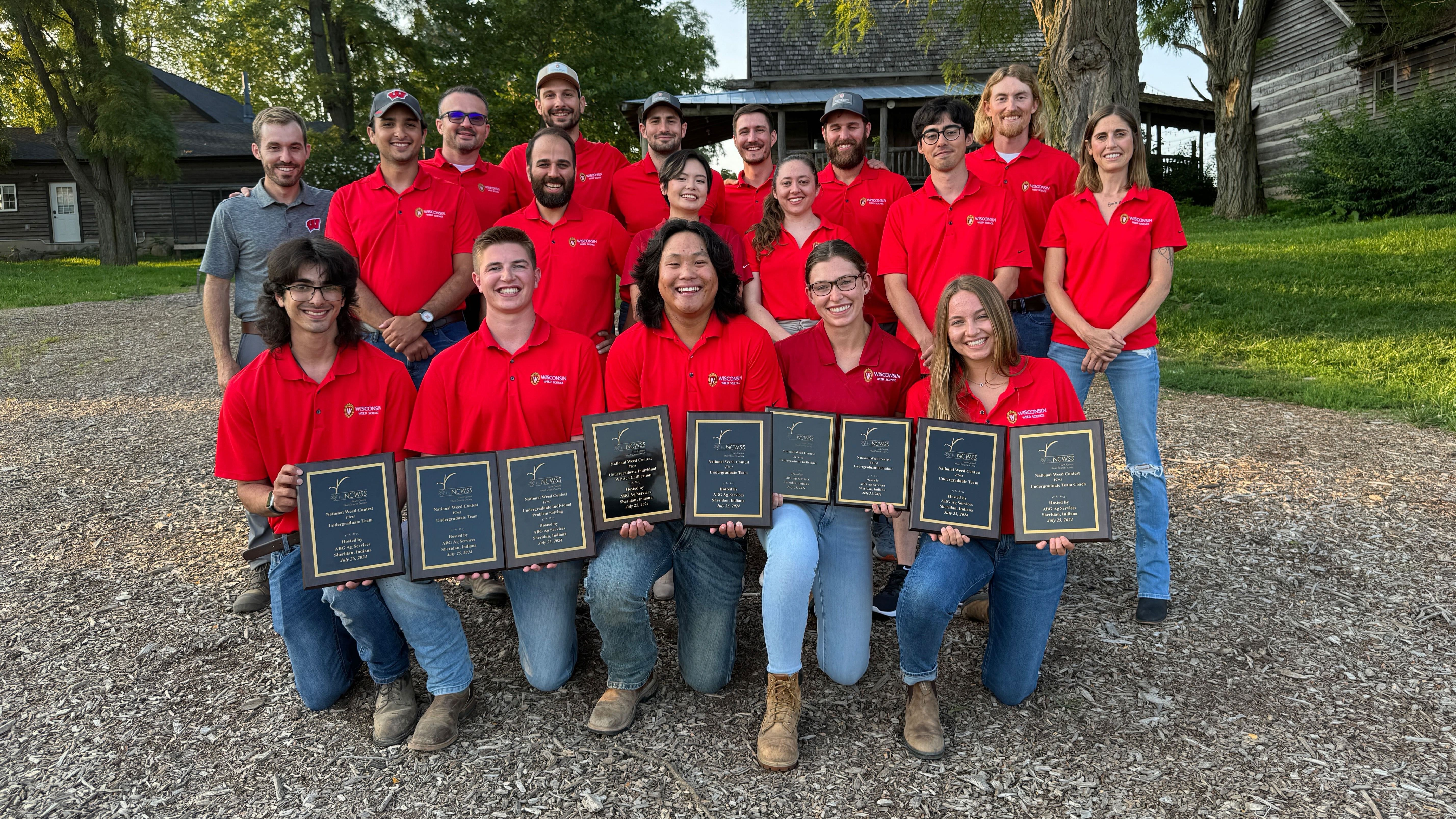 Students and employees from UW-Madison pose in three rows for a picture.