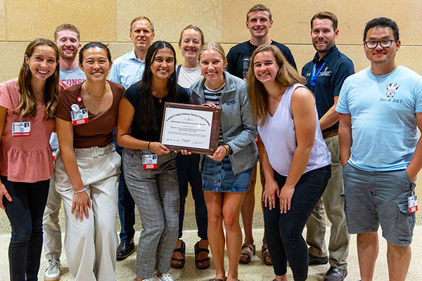 FMIG students pose with 2024 Program of Excellence certificate.