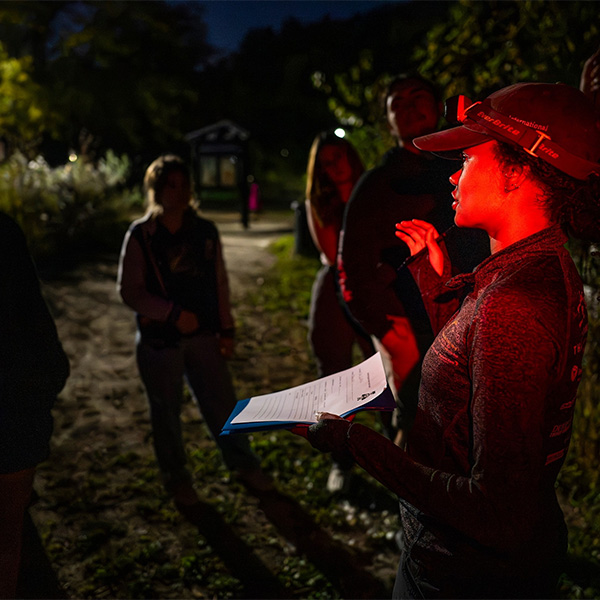 UW Bat Brigade member, Tayah Dean, speaking to group of attendees during nighttime walk.