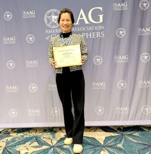 Woman smiling with a certificate