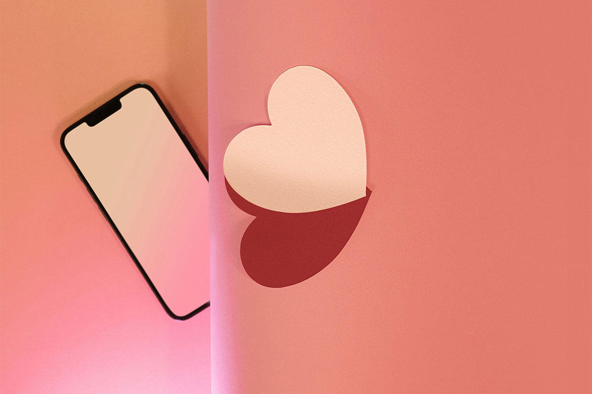 Graphic of a cutout heart next to a cellphone