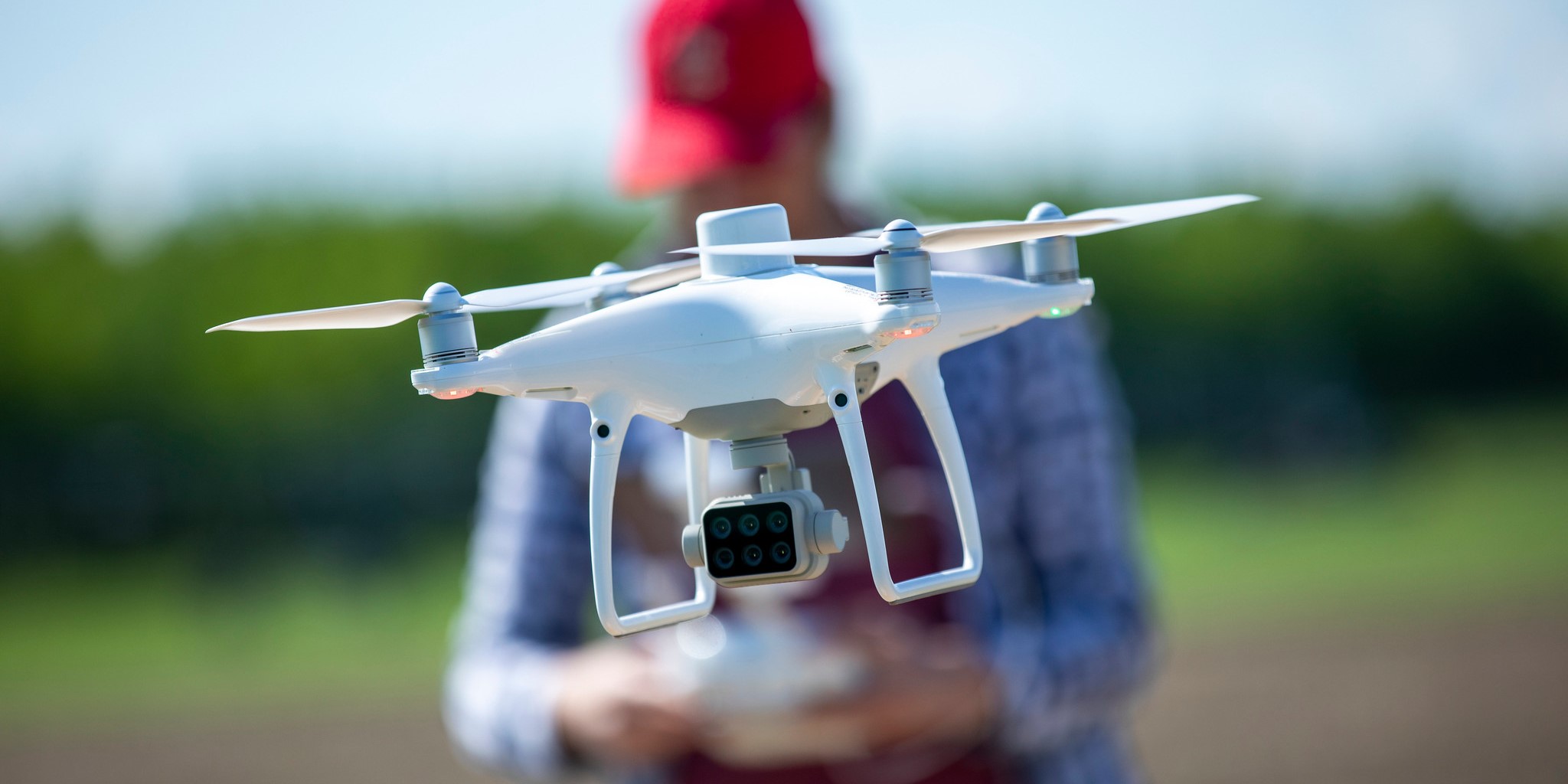 A person flies an agricultural drone.