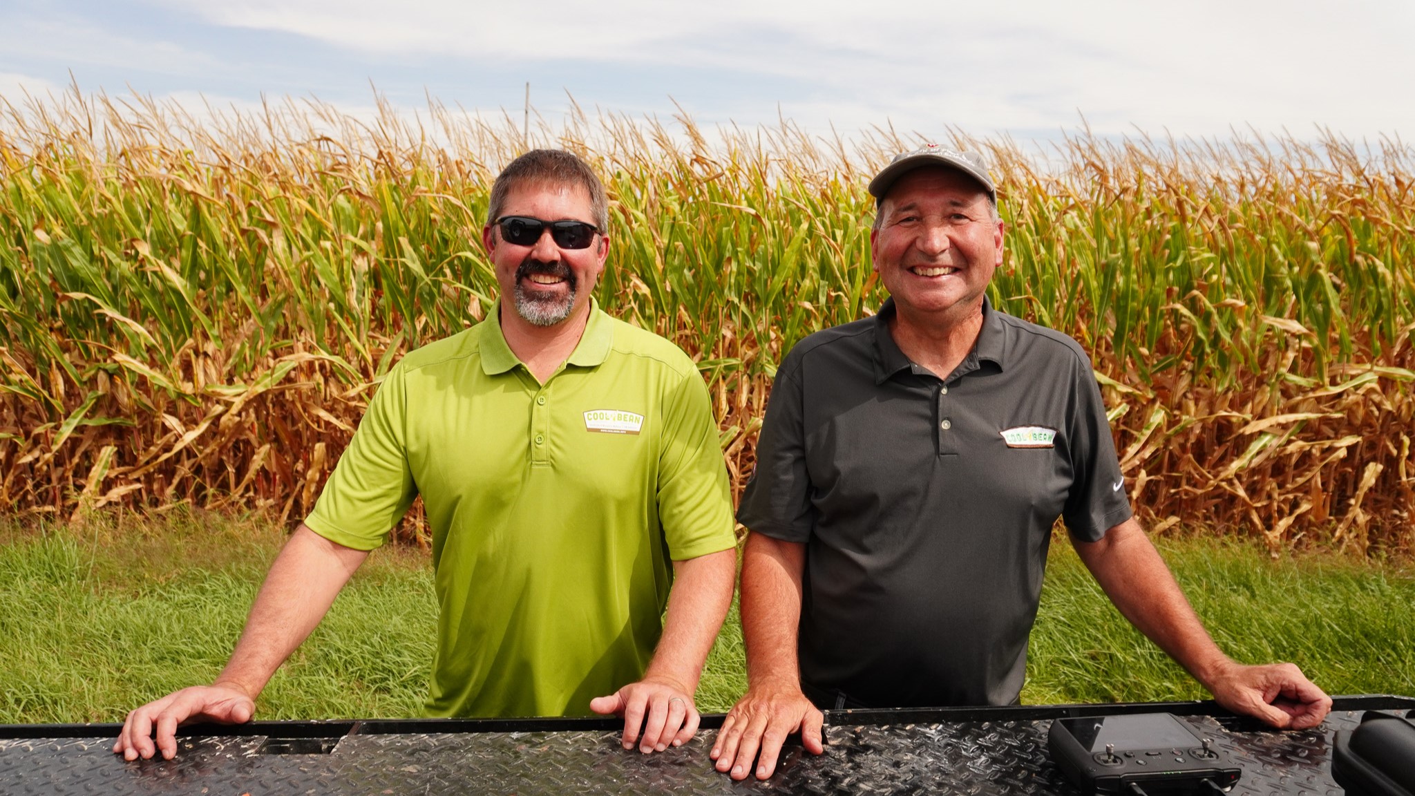 Shawn Conley and John Gaska smile. They both wear CoolBean polos.