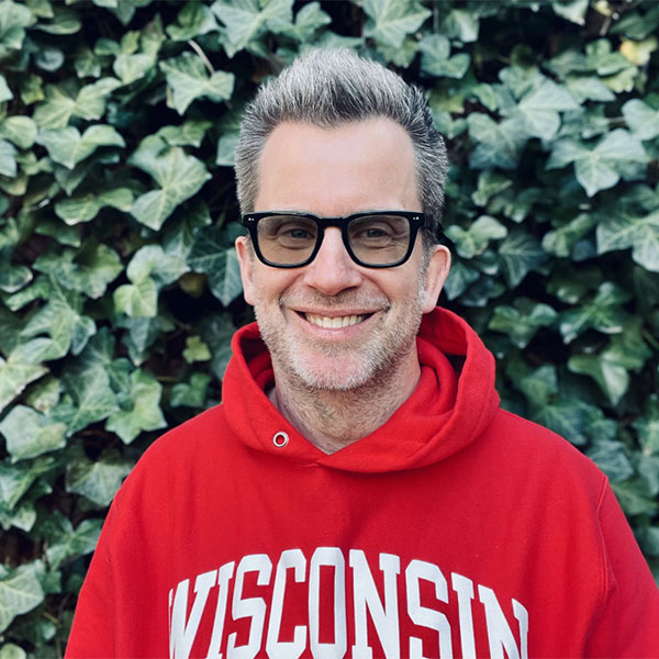 Headshot of Jason Gay wearing UW-Madison sweatshirt