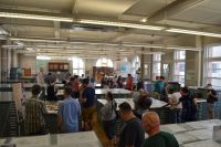 People look at maps inside the map library