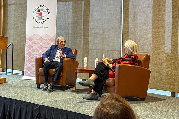 Andy Lack and Kathleen Batzen Culver sit in armchairs on a stage and converse during an event