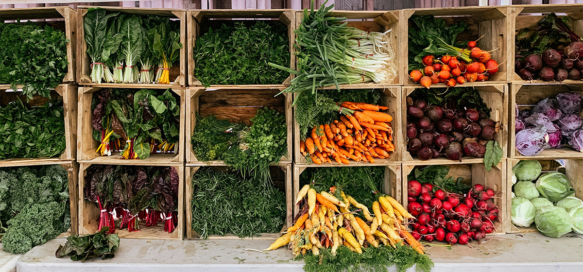 Stock photo of vegetables being sold at a farmers market.