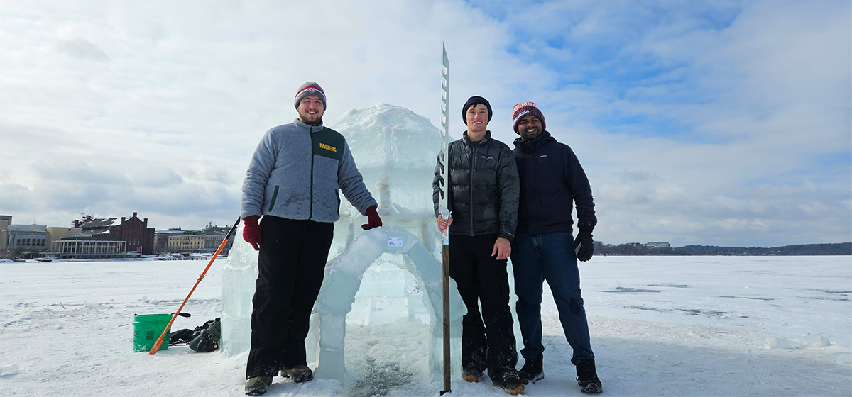 L&S undergraduate, Henry Fries, stands with friends in front of an Igloo built on the frozen Lake Mendota