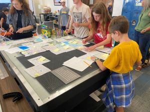 Two middle schoolers work at a table
