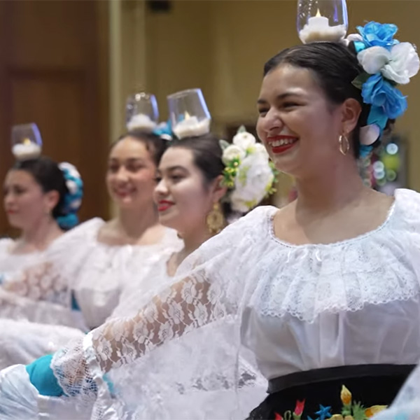 Students in traditional clothing preforming Mexican folklore dance