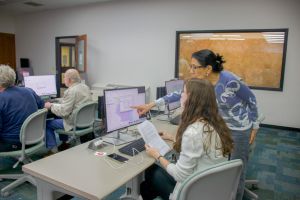 Two women look at a computer screen together