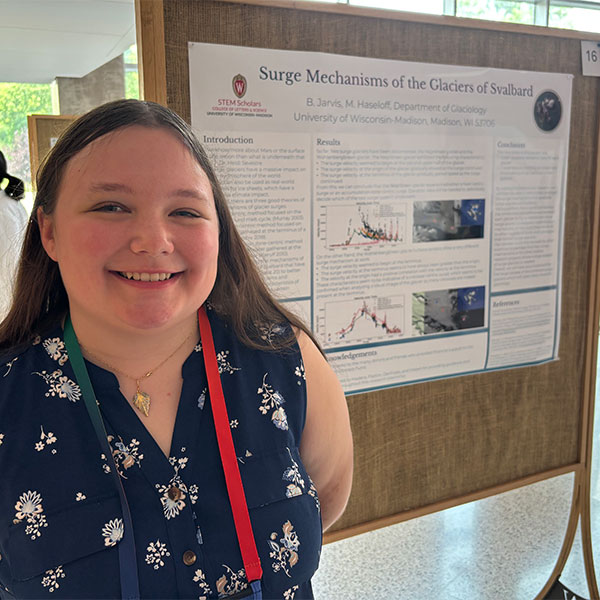 Bethany Jarvis standing infront of research poster.