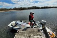 Eric Giese on a boat preparing for fieldwork