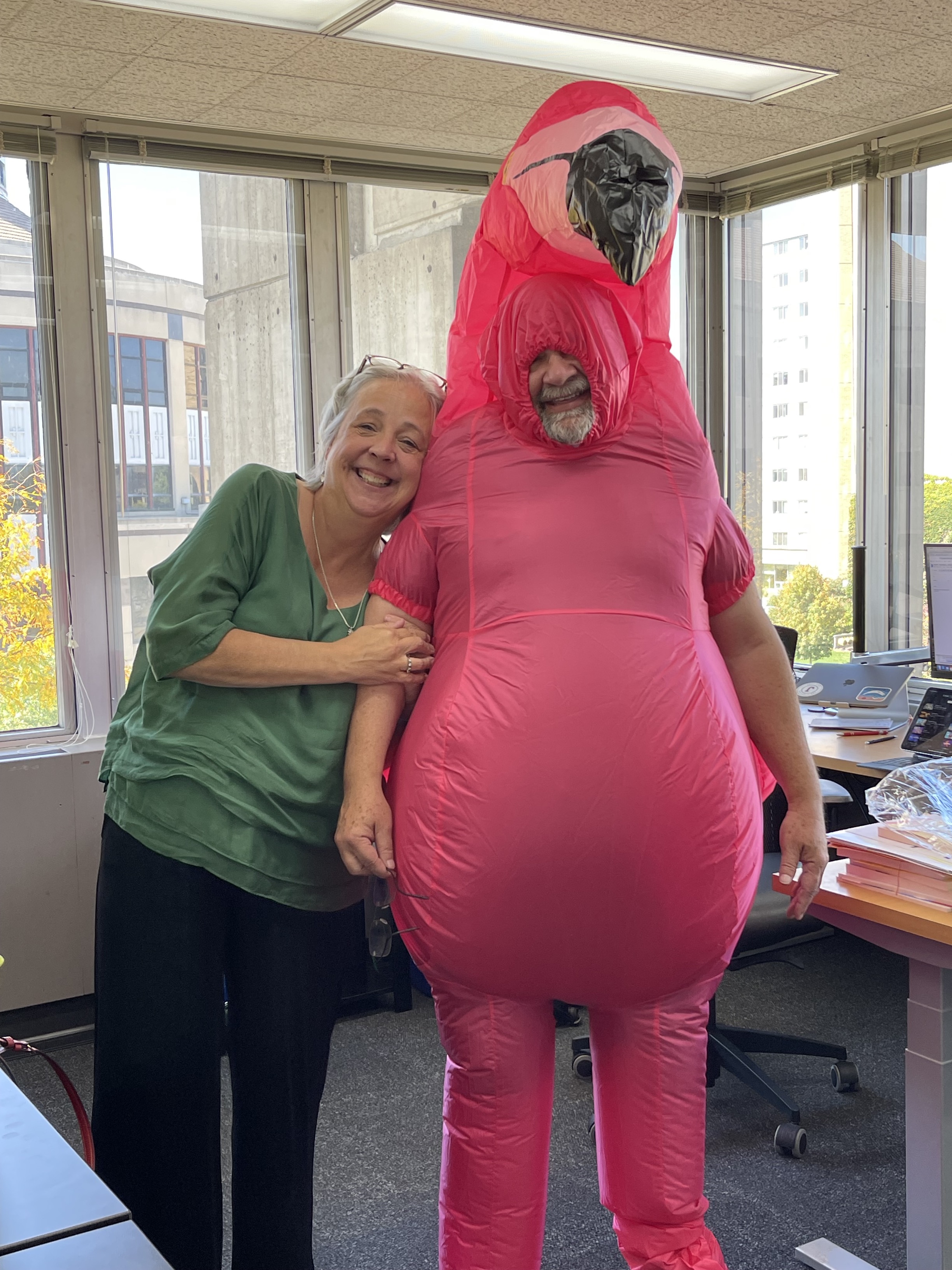 Professor Doug McLeod wears a flamingo costume and poses with director Katy Culver
