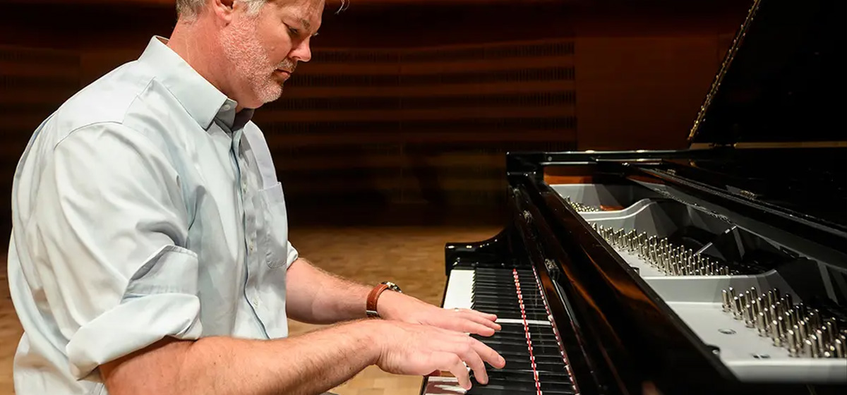 Director Dan Cavanagh playing piano.