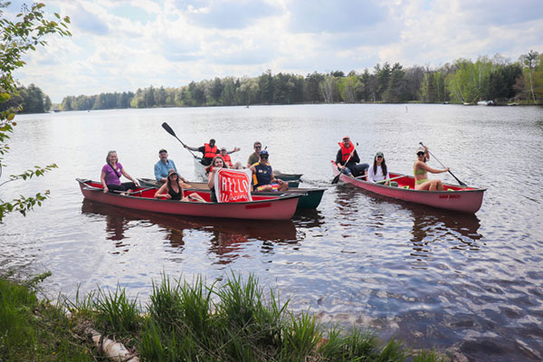 Shelly Shaw, seated at the back of the canoe on the left, explores Legend Lake during a water workshop led by Marla Mahkimetas, a Menominee water educator and artist.