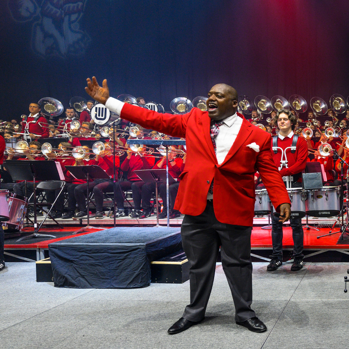 Image of Corey Pompey waving to the crowd during the UW Varsity Band Spring Concert. Photo by Althea Dotzour.