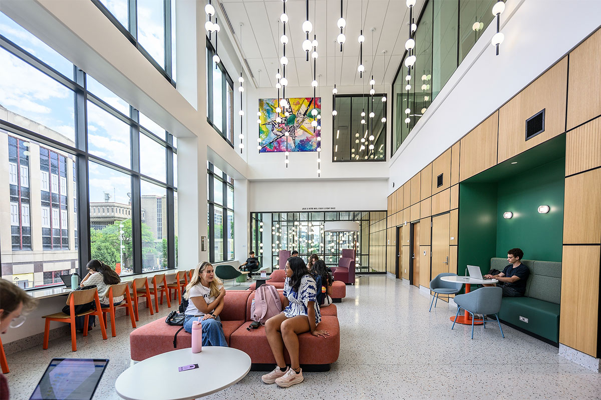 New students waiting in atrium for their class to start in the new Irving & Dorothy Levy Hall on the first day of the fall semester.