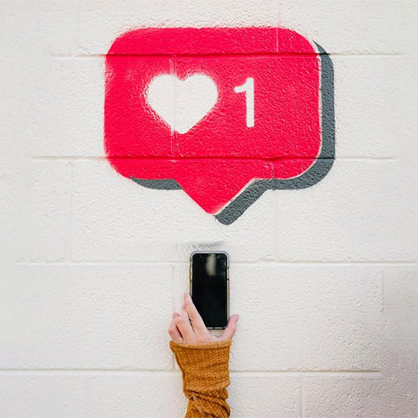 Digital Girlhood book cover of young girl holding cellphone with liked icon above it