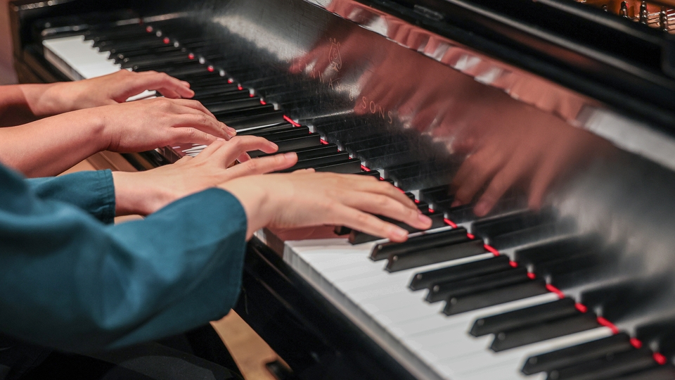 Doctoral Students Minha Jeon and Eunsu Kim play a piece arranged for four hands.