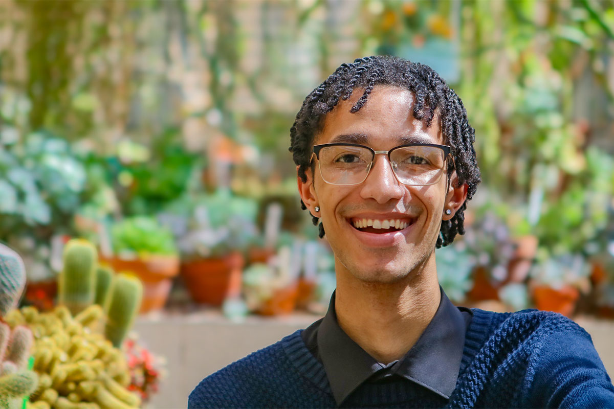 Devin Guthrie selfie with botanicals in background.