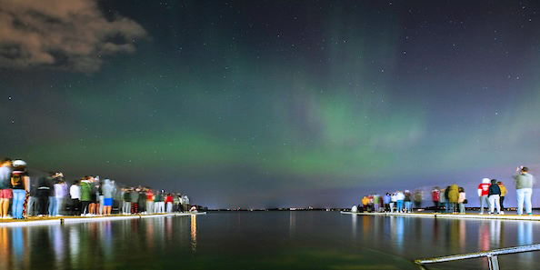 Students observing Northern Lights at night