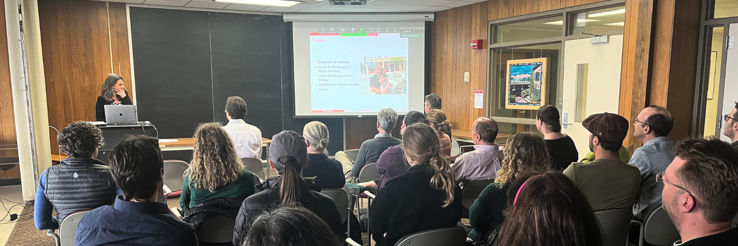 Michal Engelman at the front of a room presenting the Sewell Memorial Lecture to a group of people.